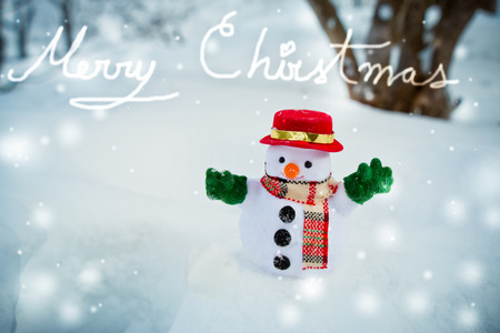 Snow man stand among pile of snow. Morning sunshine is warming in winter. Welcome Christmas.の写真素材