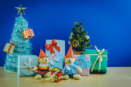 Ornament and a couple lovely teddy bear, Christmas decorate at Merry Christmas and happy new year night light. Christmas tree and other decoration with Lovely gift and ribbon .の写真素材