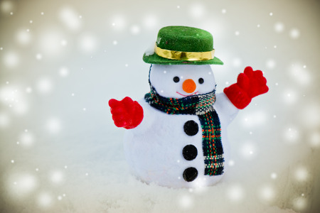Snow man stand among pile of snow. Morning sunshine is warming in winter. Welcome Christmas.の写真素材
