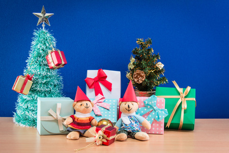 Ornament and a couple lovely teddy bear, Christmas decorate at Merry Christmas and happy new year night light. Christmas tree and other decoration with Lovely gift and ribbon .の写真素材