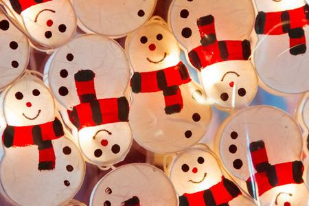 Hanging snowman Fancy light bulbs with glowing and lighting.の写真素材