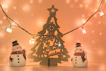2 Snowman stand near christmas tree stand on white background. Snow flake is falling down. Decoration gift for Merry Christmas and happy new yearの写真素材