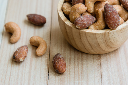 Dried salt Cashew nuts in a bowl on wooden table backgroundの写真素材