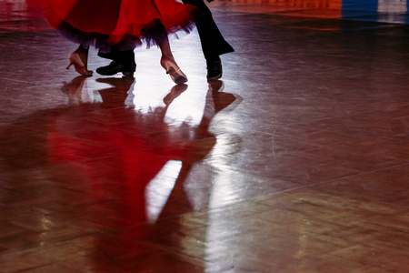 Motion blur of couple dancers in a dance spotlight on the floor, during Grand Slam Standard dance.の写真素材