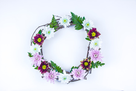 Floral and branch round crown(wreath) white daisy and green leaf. Isolated white background. summer and spring. Space for text. Flat lay, top viewの写真素材