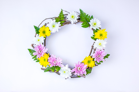 Floral and branch round crown(wreath) white daisy and green leaf. Isolated white background. summer and spring. Space for text. Flat lay, top viewの写真素材