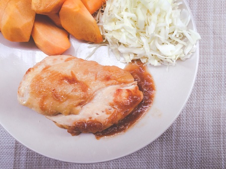 Fried chicken, grilled with black hot pepper, French fries chips and vegetable salad and breadの素材