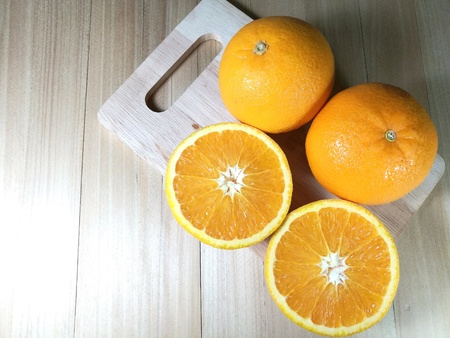 Fresh orange fruit isolated on wooden background. Orange slice.の素材
