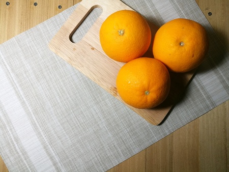 Fresh orange fruit isolated on wooden background. Orange slice.の素材