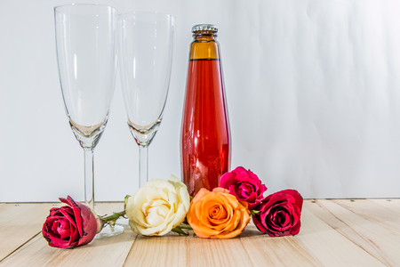 Rose on wood floor with Champagne and glass set for celebrate in party.の写真素材