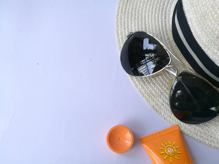 Flat lay view of summer and travel accessories. Hat, sun glasses, sunblock cream protection and camera.の写真素材