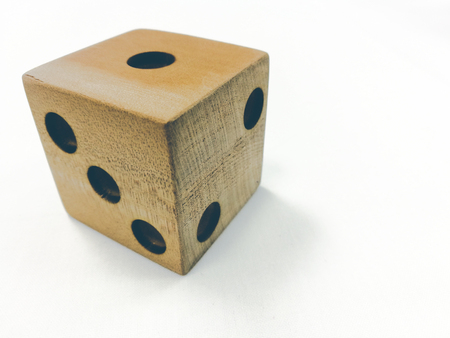 wooden dice put near 2 black pens and paper noteの写真素材