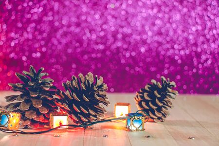 pine oak and ornament at silent night.  light up glitter background. Merry christmas and happy new...