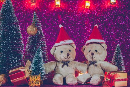 couple bear at silent night with Christmas tree and ornament, light up glitter background. Merry christmas and happy new year night.の写真素材