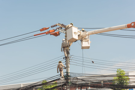 Electrician on the pole to repair and change the force high.のeditorial素材