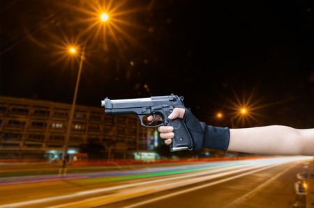 Woman holding hand gun isolated white background cliping part.の写真素材
