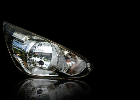 Car headlight isolated from background ha white.