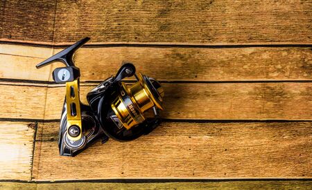 Reel for Big Fish isolated from the wooden background.の写真素材