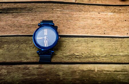 steel clock on wooden background.の写真素材