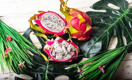 Dragon fruit or pitaya with slice isolated on ornamental leaf background, exotic tropical diet nutrition Foodの写真素材