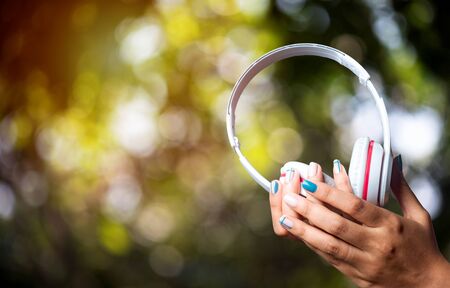 Woman hand holding the headset White technologyの写真素材