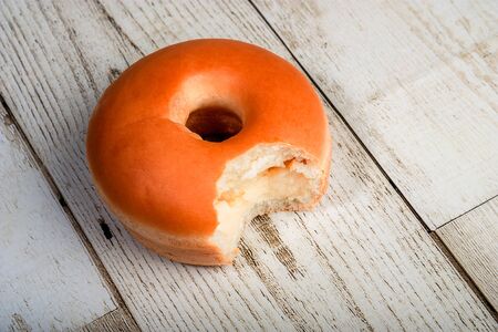 Donut eating milk filling on the wooden floorの写真素材