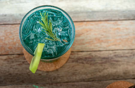 Delicious kiwi soda water sweet and fragrant in a glass of ice cold on the wood floor jpg
