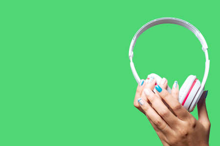 Woman hand holding the headset White technology