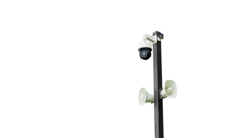 Cctv camera system Loudspeaker broadcasting on a steel column separated from a white background...