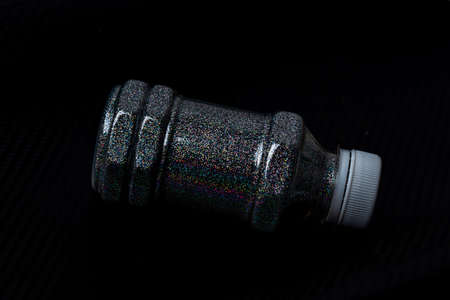 Hologram flakes in a bottle on a floorの写真素材