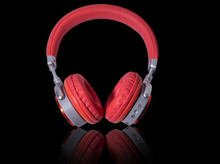 Red headphone and cable isolated on background.HeadphonesRed headphoneTechnologyの写真素材