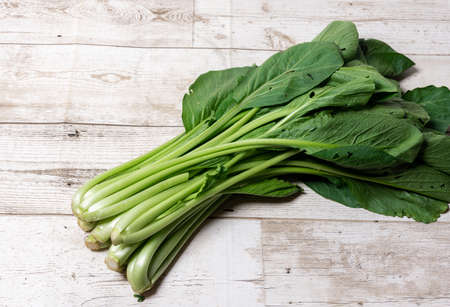 Bok choy on wooden floor, Bok choy or Chinese-cabbage on wooden board and wooden floor.Bok choy is the best leafy green vegetable.の写真素材