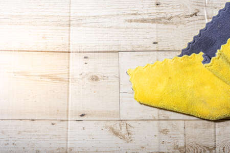 Microfiber ceiling cleaning and rubbing an hardwood floor with a microfiber cloth.の写真素材
