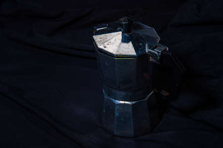 Moka Pot on a wooden floor Coffee pot on a frosted black backgroundの写真素材