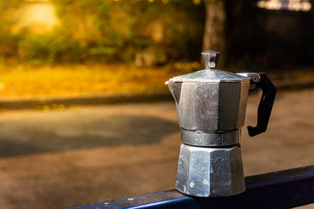 Metal coffee maker on the background of the road in the park.の写真素材