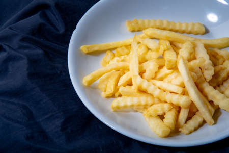 French fries in a plate French fries in a plate. on a dark background