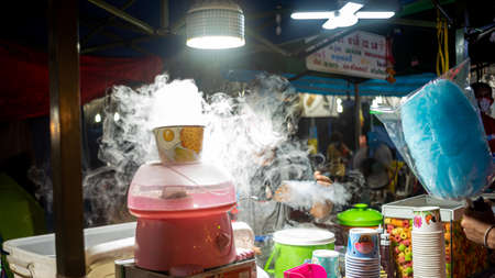 Street food vendor selling cotton candy at street food market.の写真素材