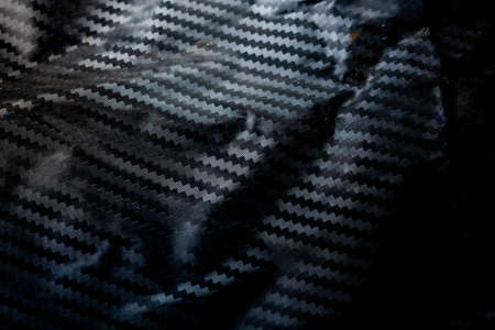 Kevlar Carbon fiber composite raw material background uneven wallpaper technologyの写真素材