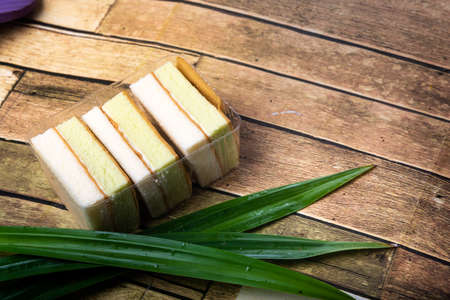 Pandan cake on the wooden floor sweet, soft, delicious food background with high resolutionの写真素材