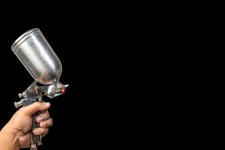 Blurred background paint sprayImage of the painter's arm hand holding industrial size spray gun used for industrial painting and coating and isolated on white background clipingpartの写真素材