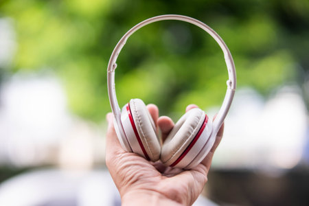 hand holding headphones system wifi 9.1 ch 3d audio technology on background background blur bokehの写真素材