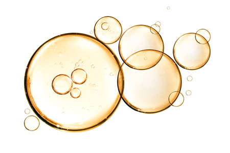 golden yellow bubble oil or serum isolated on white backgroundの写真素材