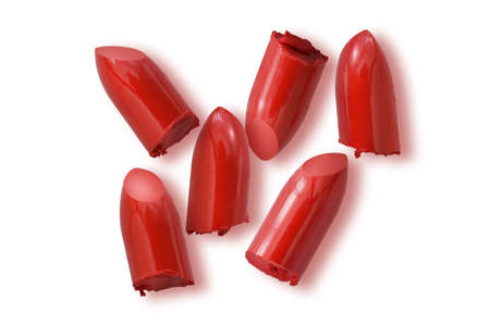 red lipstick bullet with shadow on white background beauty and fashion conceptの写真素材