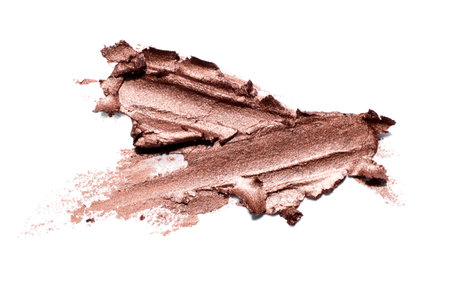 Smear of gold matte creamy eye shadow or metallic lipstick isolated on white background luxury make up conceptの写真素材