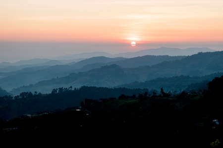 Scenery amazing sun rise between many mountains on beautiful fog cloudy sky landscapeの写真素材