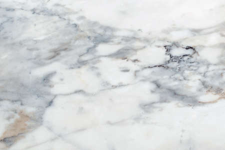 cracked light brown gray marble that happening mineral and metal organic rock environment on fading white natural stoneの写真素材