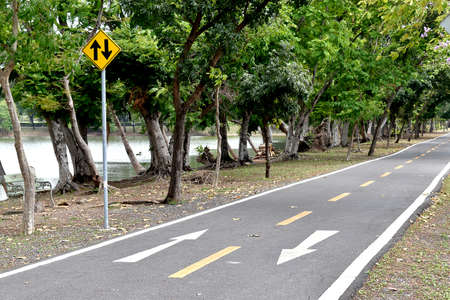 Arrow symbol on lenses in the park with traffic signの写真素材