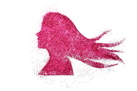 pink pigment glitter shiny silhouette woman head on white background creative conceptの写真素材