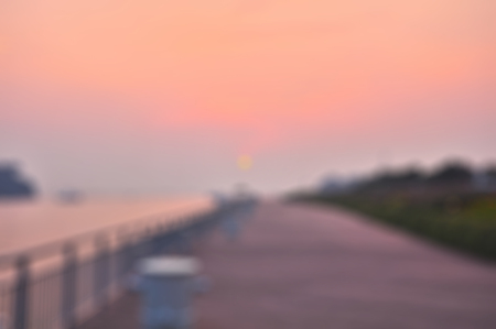 Blurred background of beautiful sunset at a riverside walkwayの写真素材