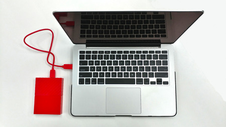 Portable/External Hard Drive(HDD) connected to laptop for data transfer (Top View)の写真素材